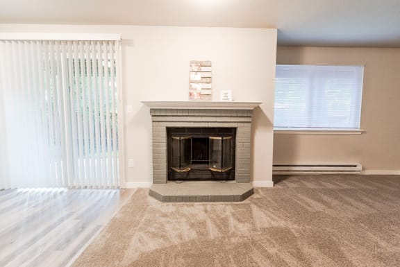 a living room with a fireplace and a window&#xA0;at Cambridge on Seventh, Washington, 98372