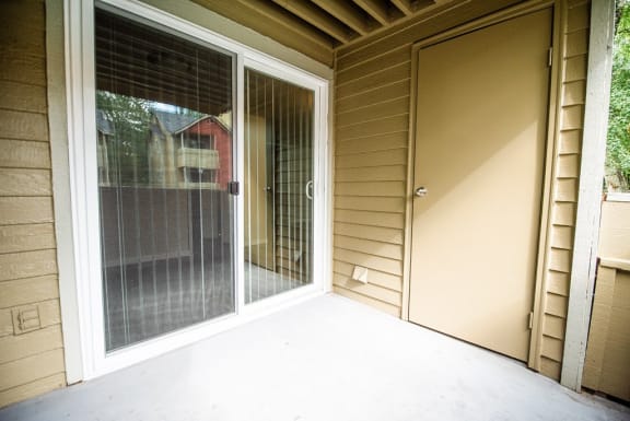 a porch with a door and a sliding glass door&#xA0;at Cambridge on Seventh, Puyallup, WA, 98372