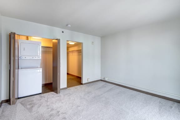 the living room of an apartment with a refrigerator and a closet&#xA0;at Cosmopolitan, Washington, 98105
