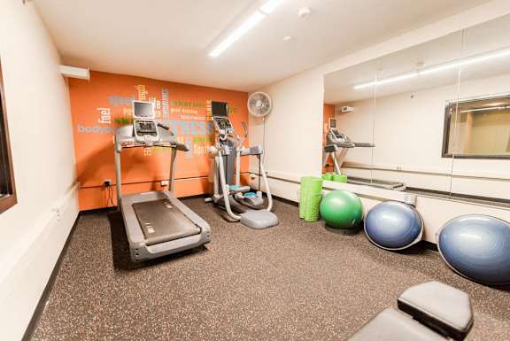 a gym with treadmills and weights on the floor at Cosmopolitan, Seattle