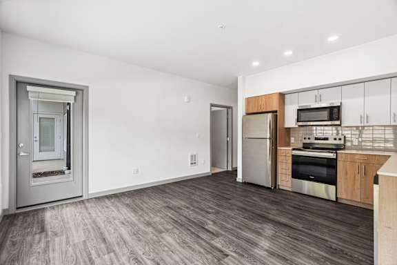 A modern kitchen with stainless steel appliances and wooden cabinets.