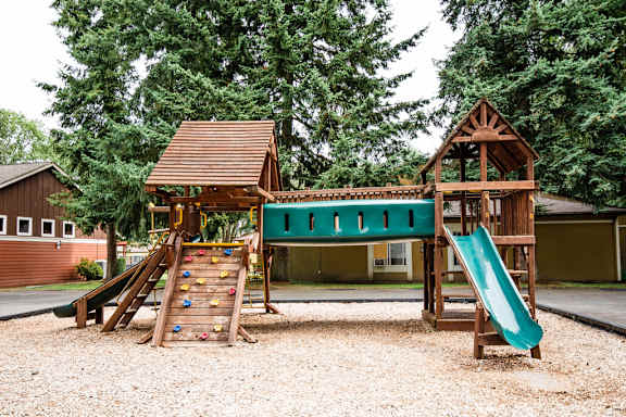 a playground with a swing set and a slide