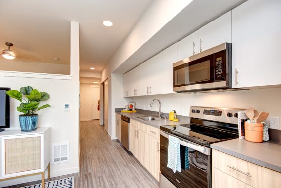a large kitchen with stainless steel appliances and a microwave