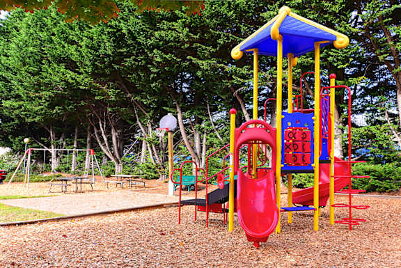 a childrens playground with a colorful swing set