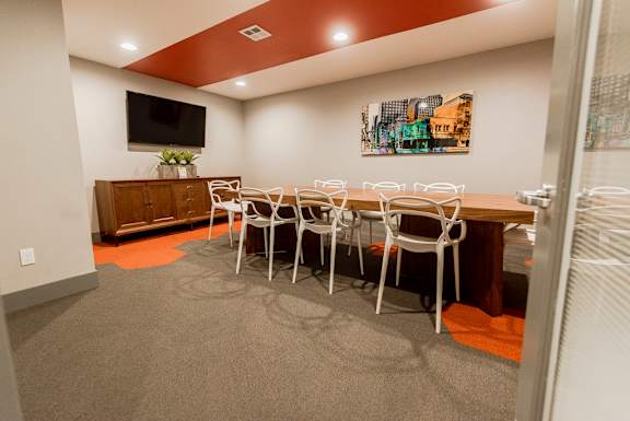 a dining room with a table and chairs and a television at Northpoint Apartments, Tacoma, 98407
