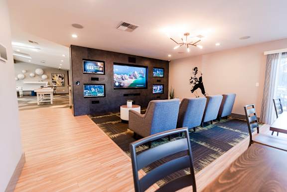 a living room with chairs and a table and a television at Northpoint Apartments, Tacoma, WA, 98407