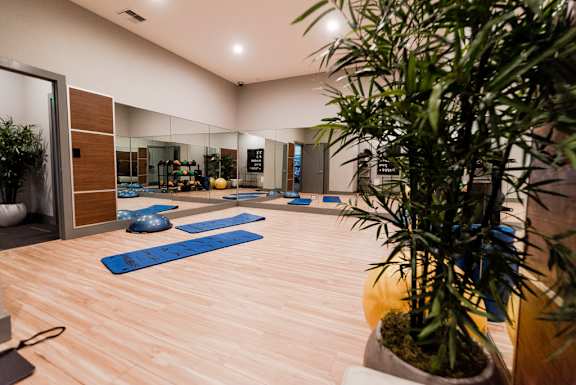 a yoga studio with plants and yoga mats on the floor at Northpoint Apartments, Tacoma, Washington