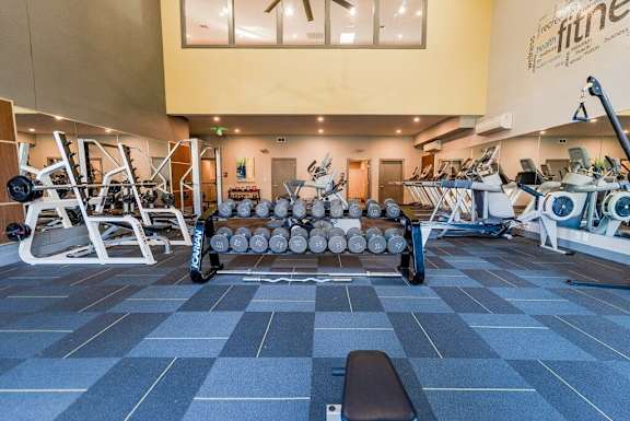 A gym with a variety of equipment including weights and machines. at Northpoint Apartments, Tacoma, WA, 98407