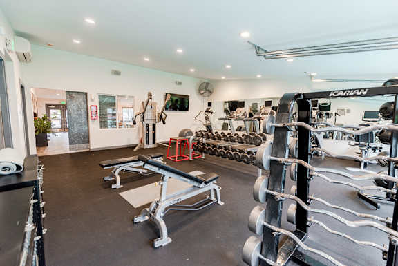 a gym with weights and dumbbells on the floor and a wall of mirrors at Notch 8, Washington, 98444