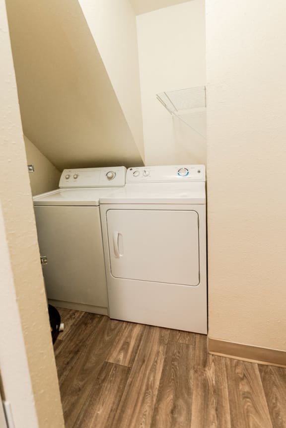 a white washer and dryer in a room with wood floors at Pacific Walk, Lakewood, Washington