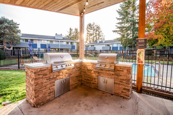 BBQ beside pool at ReVive Apartments, Washington, 98424