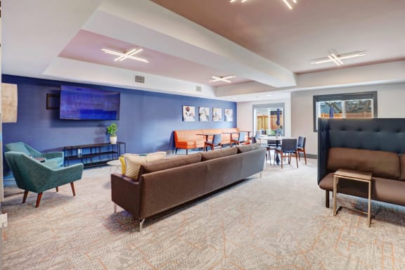 a living room with couches and chairs and a table