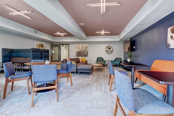 a lounge area with tables and chairs and a pool table