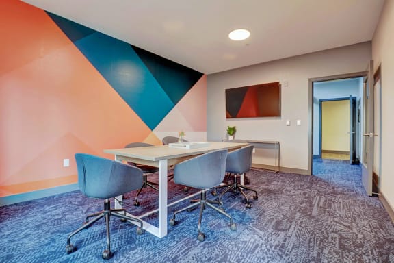 a conference room with a table and chairs