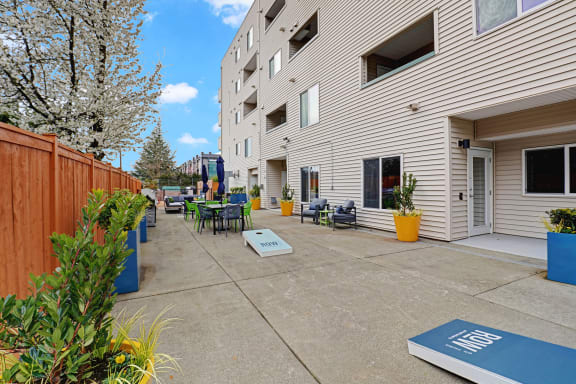a patio with tables and chairs outside of a building