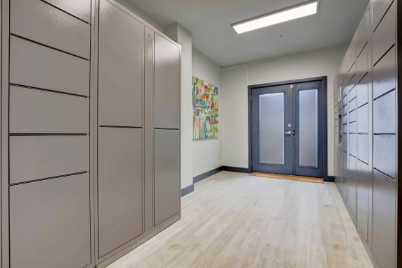 a long hallway with cabinets and a door to a closet