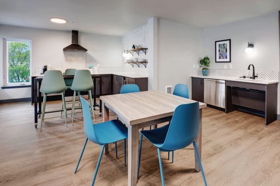 a dining room with a table and chairs and a kitchen