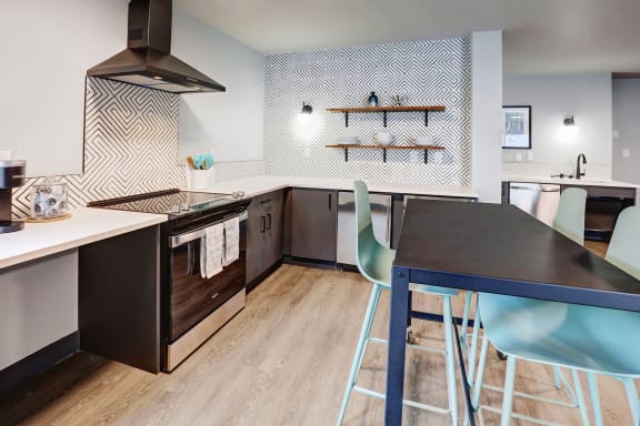 a kitchen and dining room with a table and chairs