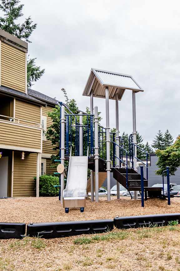 a playground with a swing set and a slide