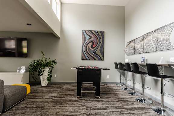 a game room with a pool table and bar stools