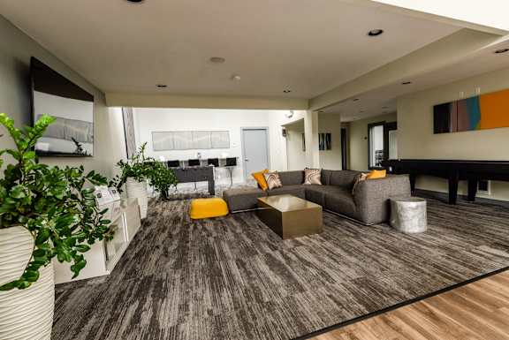 a large living room with a couch and a table