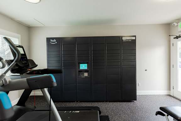a gym with a reformer and a door to a closet at The Aviator, Renton, 98055