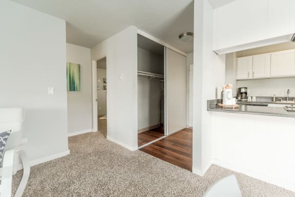 a renovated living room with a kitchen and an open door to a bedroom at The Aviator, Renton, WA, 98055