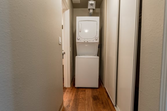a washer and dryer in a small room with a door at The Aviator, Washington