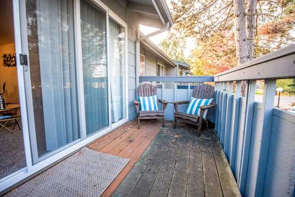 A patio with a table and chairs is shown. at The Lakes at Fife, Fife, 98424