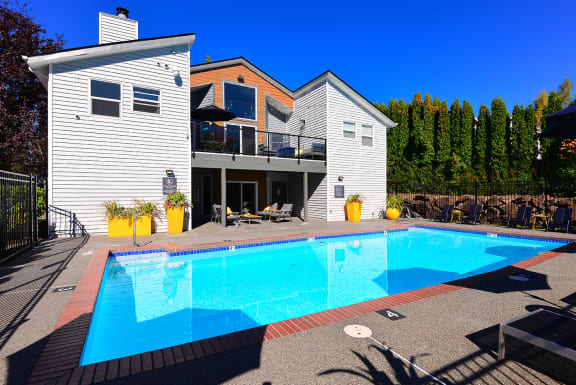 a large swimming pool in front of a house at The Lynx Apartments, Everett, WA