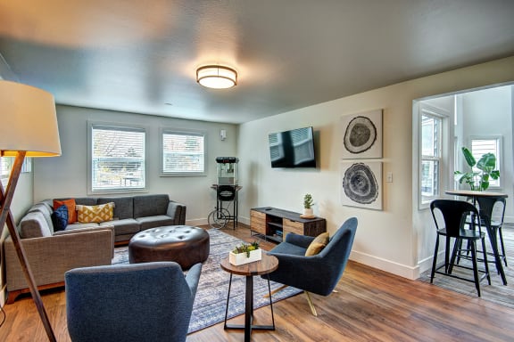 a living room with couches and chairs and a table at The Lynx Apartments, Washington