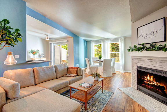 a living room with a fireplace and a couch at The Lynx Apartments, Everett, Washington