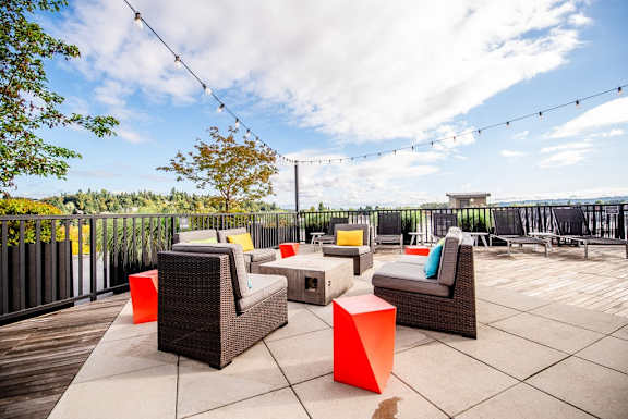 A patio with wicker furniture and a view of the sky. at The Platform, Kent, WA, 98032