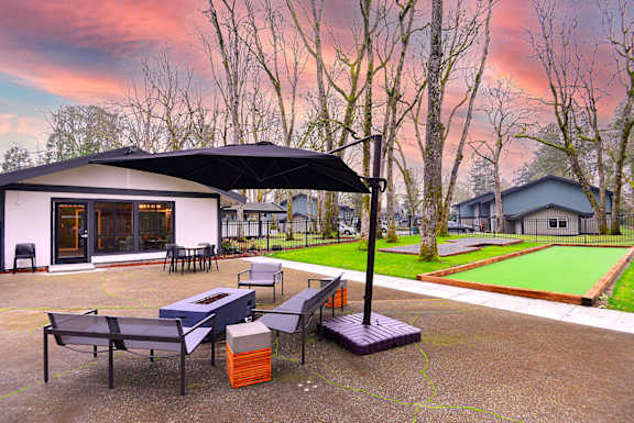 a patio with tables and chairs and umbrellas