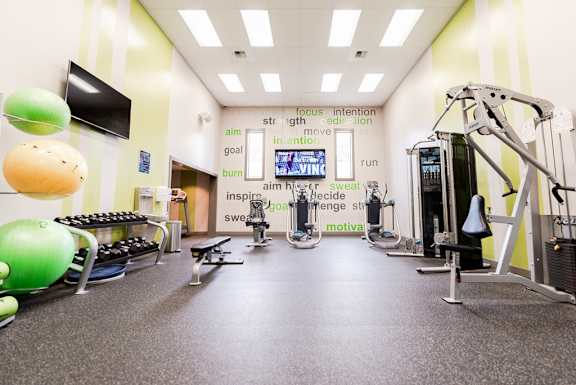a workout room with weights and other exercise equipment in a gym at Vibe, Kent, WA