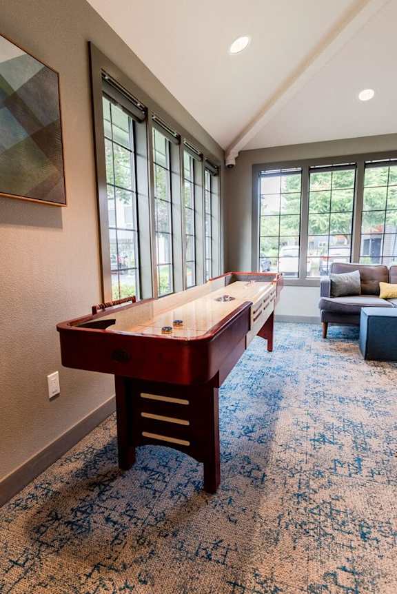 A pool table in a room with a carpeted floor.