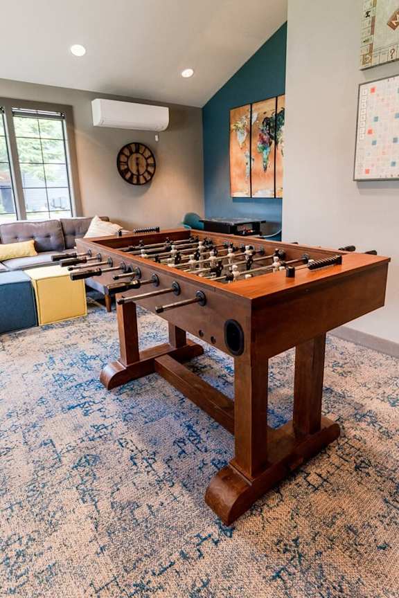 A foosball table in a room with a blue carpet.