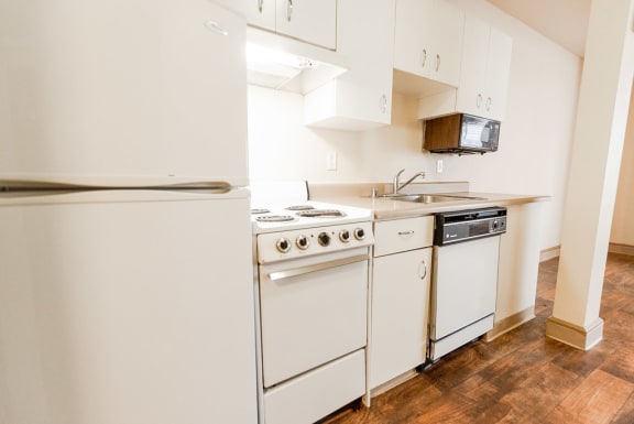 a kitchen with white appliances and white cabinets at Zindorf, Seattle, 98104