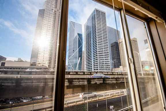 A cityscape is seen through a window with a clear blue sky. at Zindorf, Washington