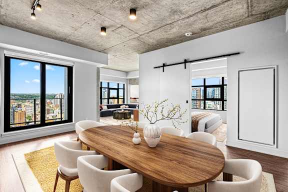 A modern dining room with a wooden table and chairs.