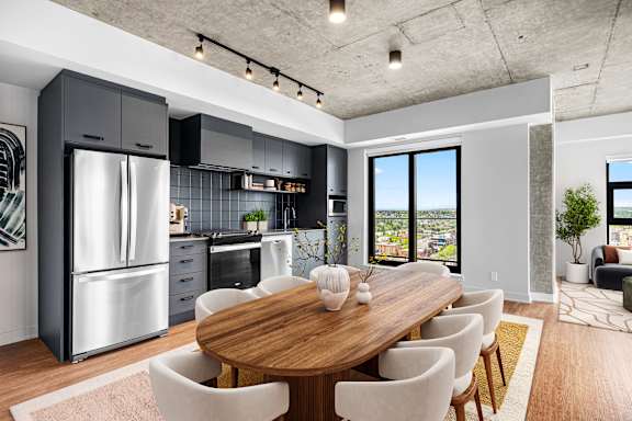 A modern kitchen with a wooden dining table and chairs.