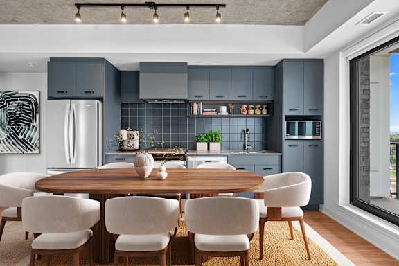 A modern kitchen with a dining table and chairs.