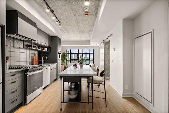 A modern kitchen with a dining table and chairs.