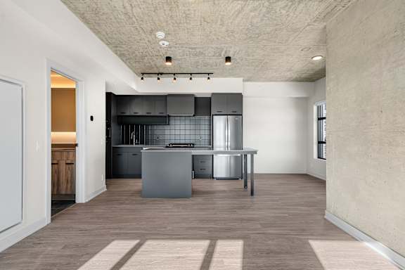 A kitchen with a large island in the middle of the room.