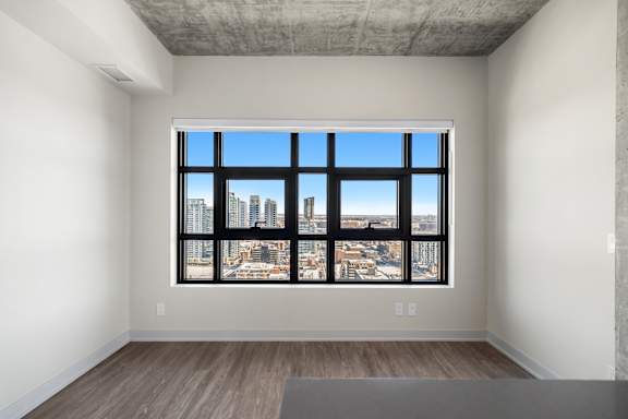 A room with a large window overlooking a cityscape.