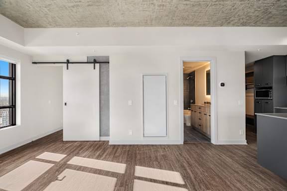 A room with a sliding door and a white door.