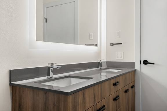 A bathroom with a sink and mirror.