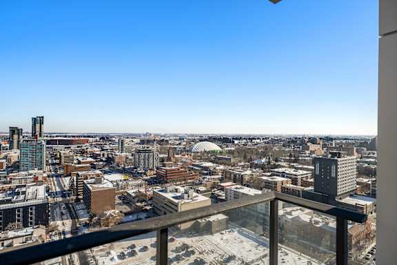 A cityscape viewed from a high vantage point with a clear blue sky.