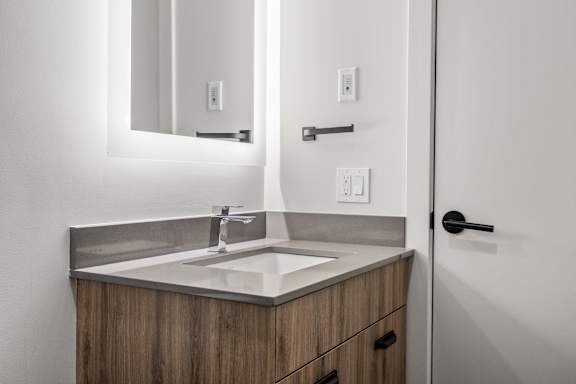 A bathroom sink with a mirror above it.