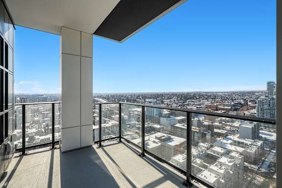 A balcony with a view of a cityscape.